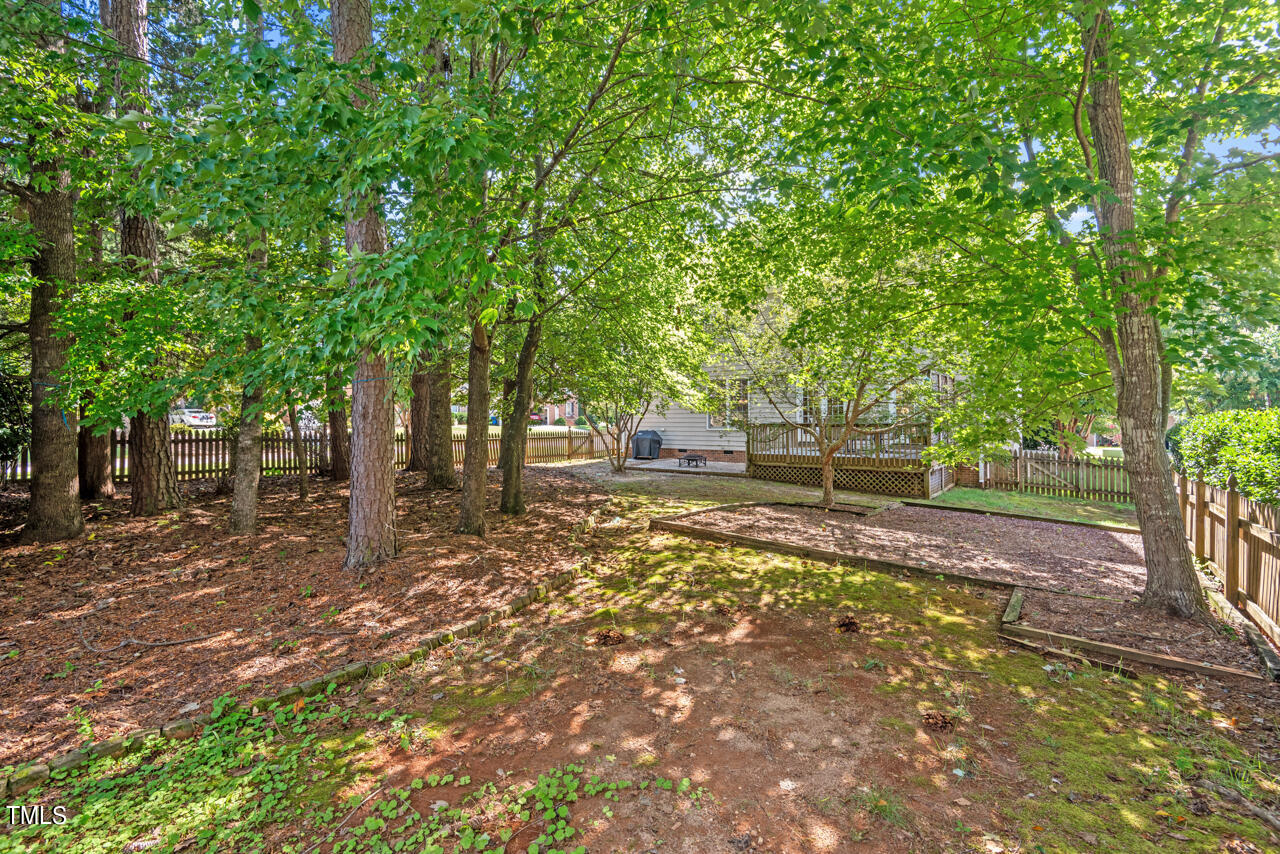 7930 Pine Timber Drive Raleigh, NC 27613 - Photo 51 of 57 a backyard of a house with lots of green space
