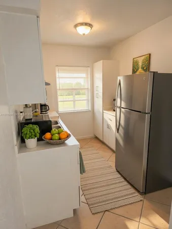 a white refrigerator freezer sitting inside of a kitchen