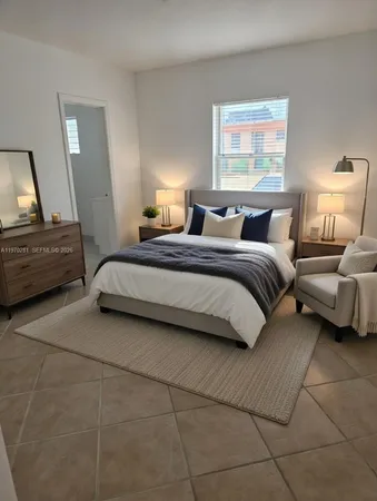 a bedroom with a bed and a couch