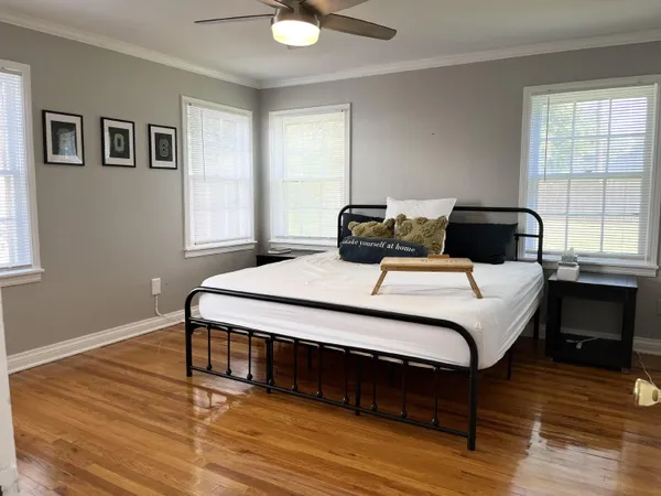 a bedroom with a bed and a chandelier