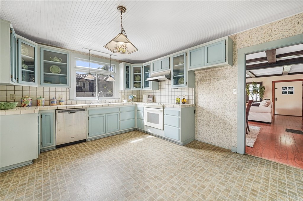 402 Virginia Street El Segundo, CA 90245 - Photo 13 of 22 a kitchen with a sink stove and cabinets