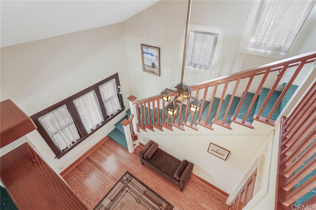 402 Virginia Street El Segundo, CA 90245 - Photo 7 of 22 a view of staircase with white walls and wooden floor