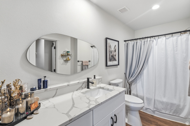 502 West 725 North Logan, UT 84321 - Photo 12 of 25 Full bath with vanity, dark wood-type flooring, and shower / bath combo