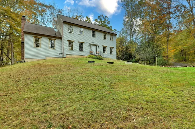 a front view of a house with a big yard