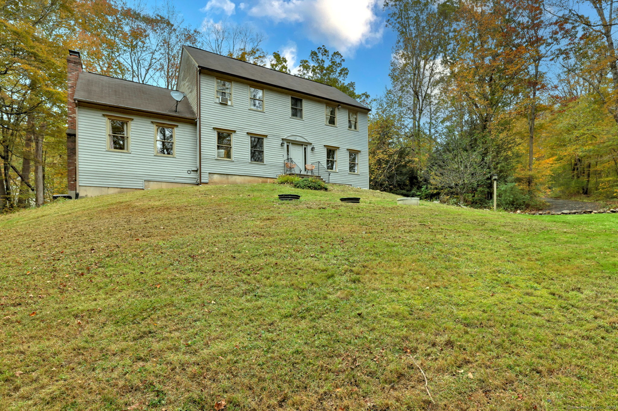 a front view of a house with a big yard