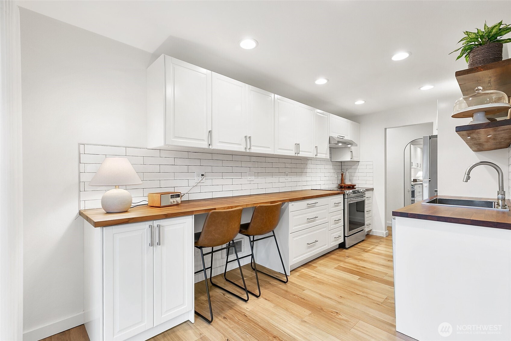 335 Heather Road, Unit 208 Everett, WA 98203 - Photo 5 of 15 a kitchen with stainless steel appliances granite countertop a sink a stove a refrigerator and island with wooden floor