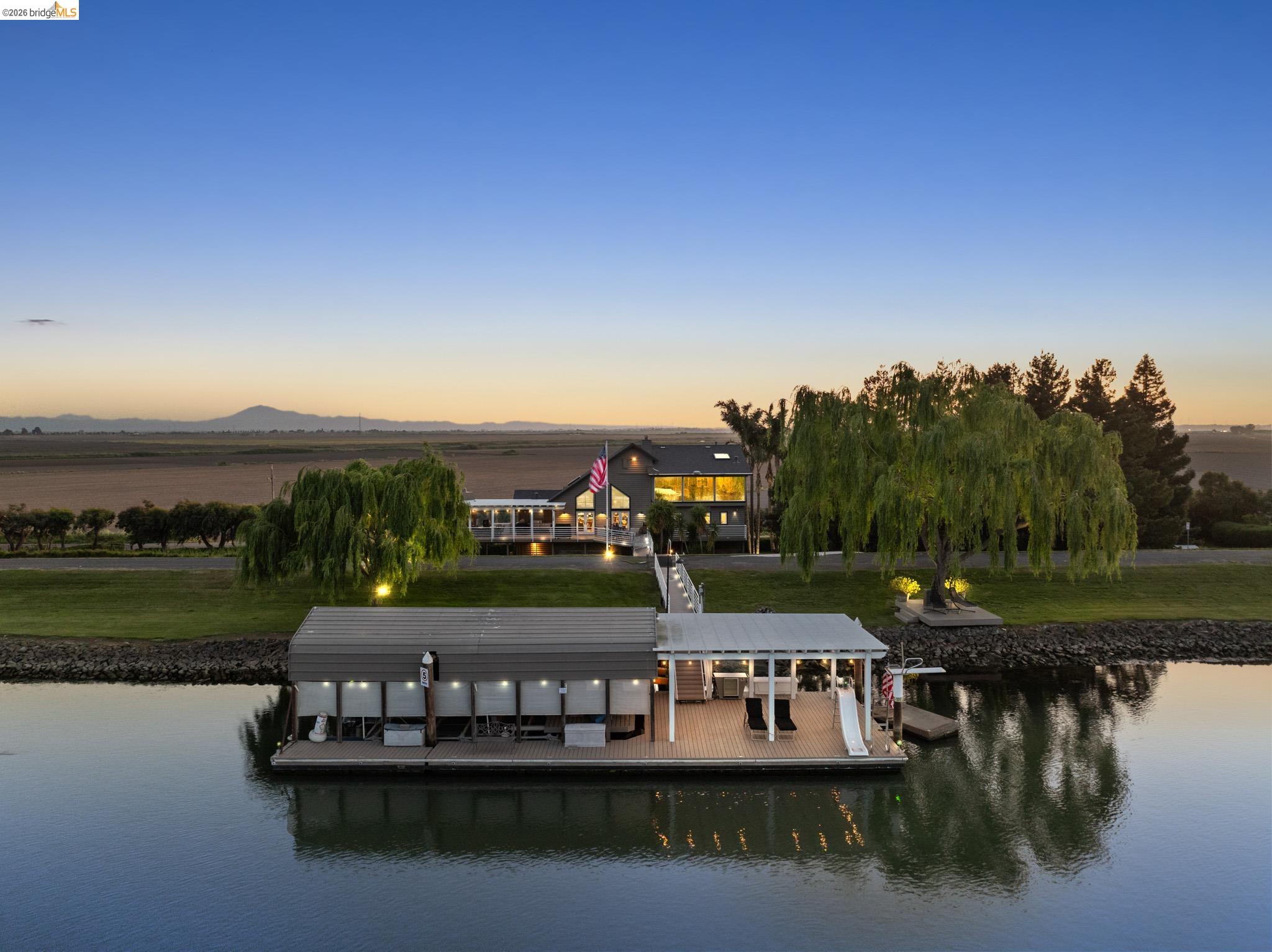 Dock featuring a water view and a lawn