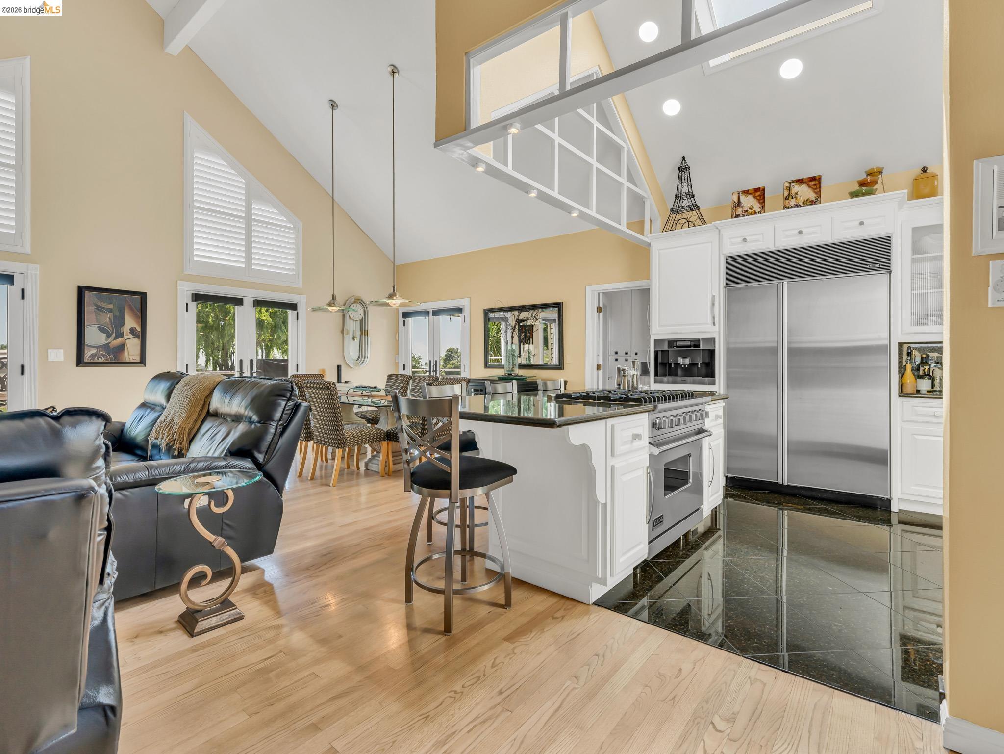 17035 Terminous Road Isleton, CA 95641 - Photo 47 of 48 Kitchen featuring open floor plan, premium appliances, white cabinets, a breakfast bar, and lofted ceiling