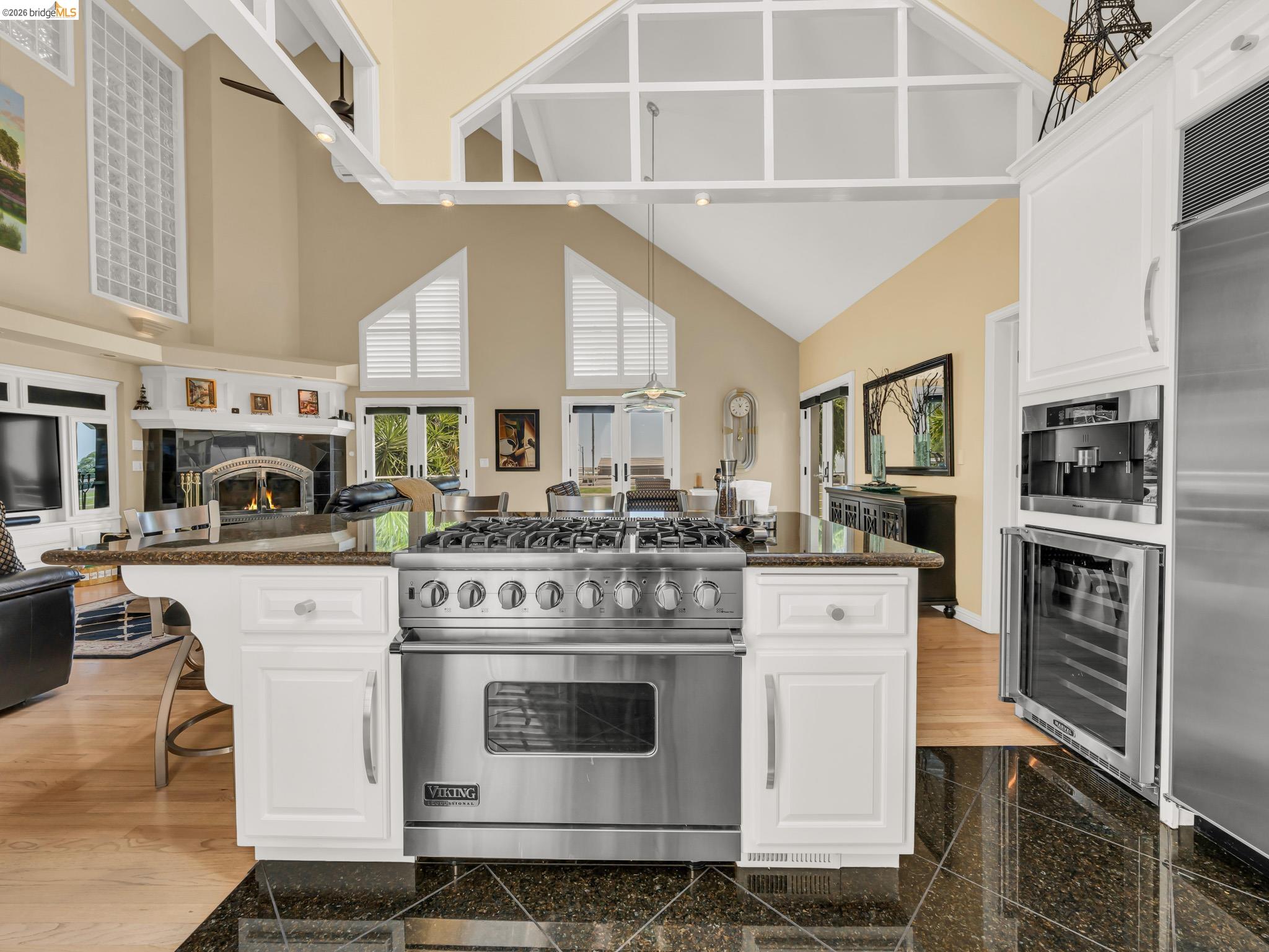 17035 Terminous Road Isleton, CA 95641 - Photo 48 of 48 Kitchen with white cabinets, high end appliances, open floor plan, wine cooler, and a kitchen breakfast bar
