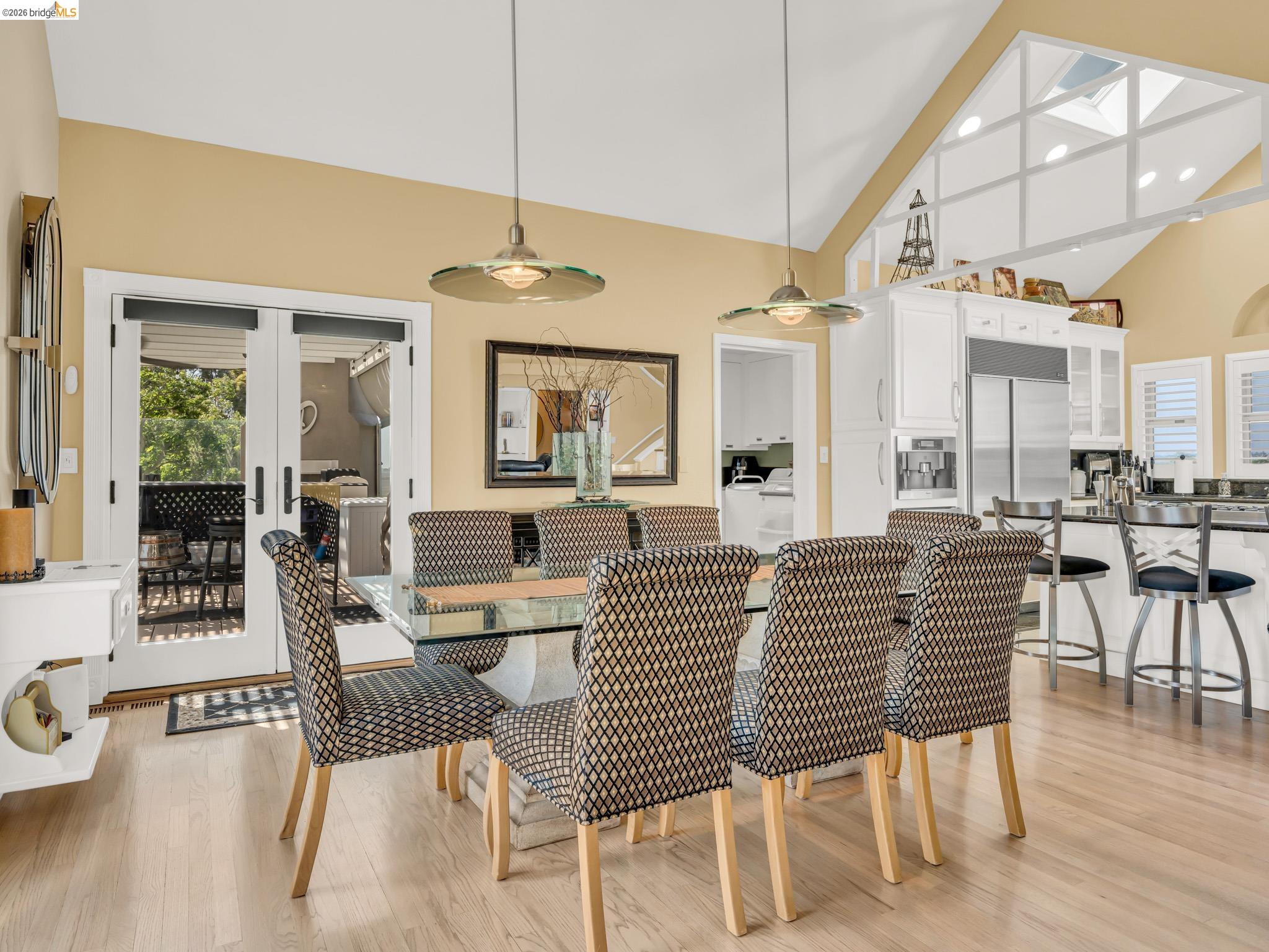 17035 Terminous Road Isleton, CA 95641 - Photo 25 of 48 Dining space featuring light wood-type flooring, vaulted ceiling, french doors, and washer / dryer