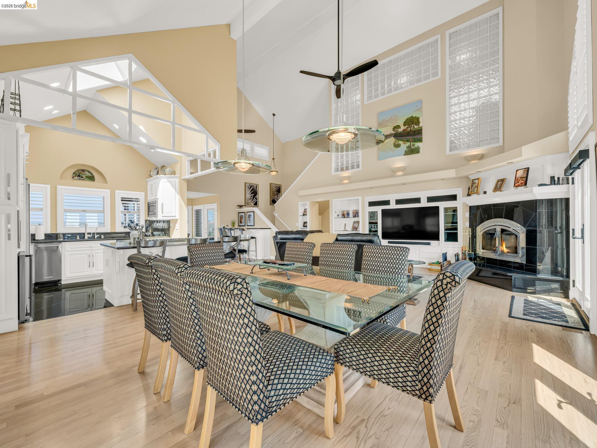 17035 Terminous Road Isleton, CA 95641 - Photo 26 of 48 Dining area with a ceiling fan, light wood-style flooring, vaulted ceiling, and a tiled fireplace