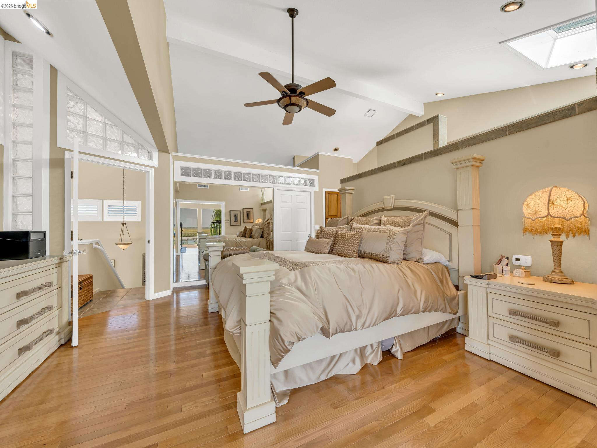 17035 Terminous Road Isleton, CA 95641 - Photo 28 of 48 Bedroom with a skylight, light wood-style floors, vaulted ceiling, and a ceiling fan