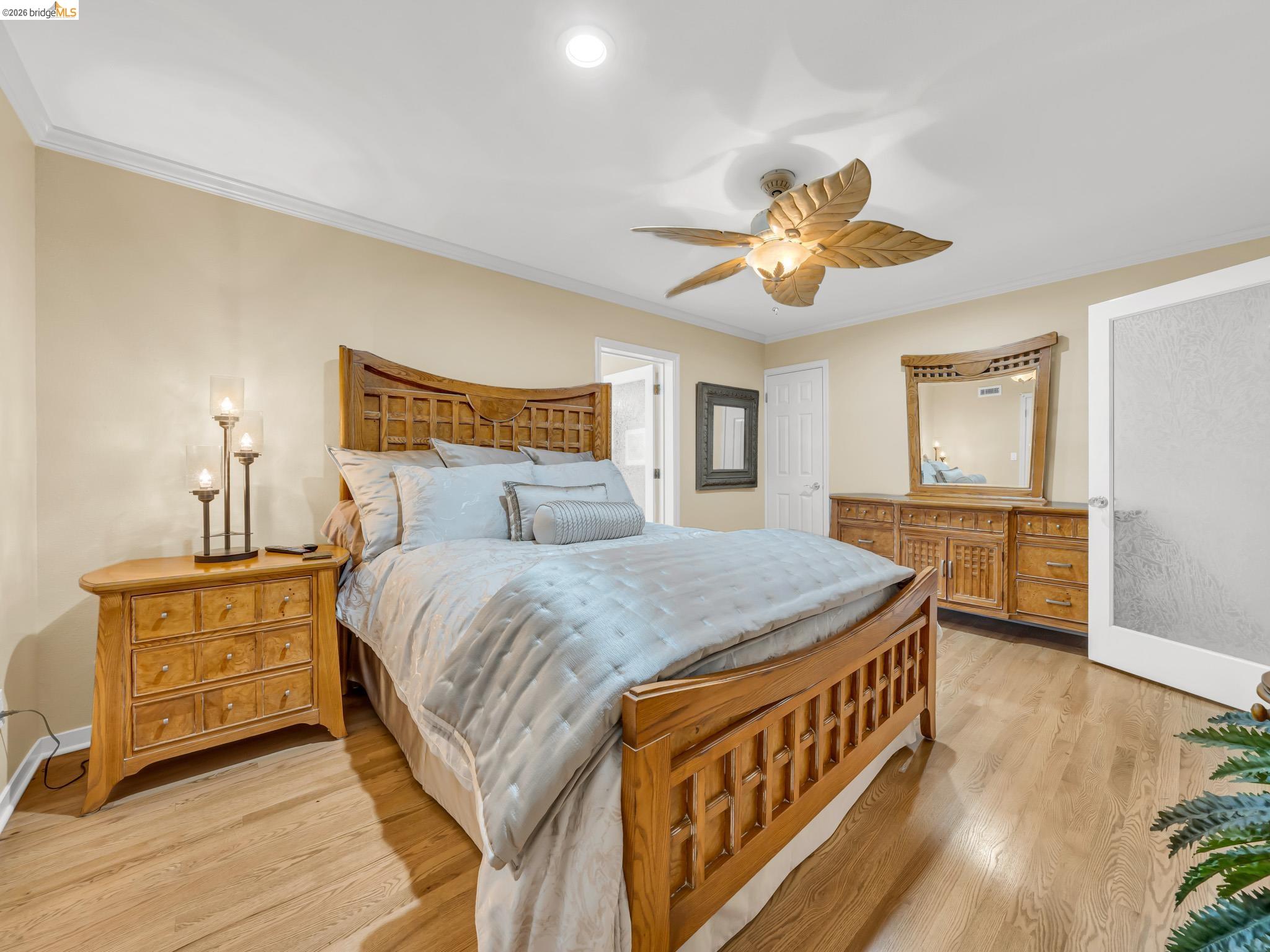 17035 Terminous Road Isleton, CA 95641 - Photo 32 of 48 Bedroom with crown molding, light wood-style floors, and ceiling fan