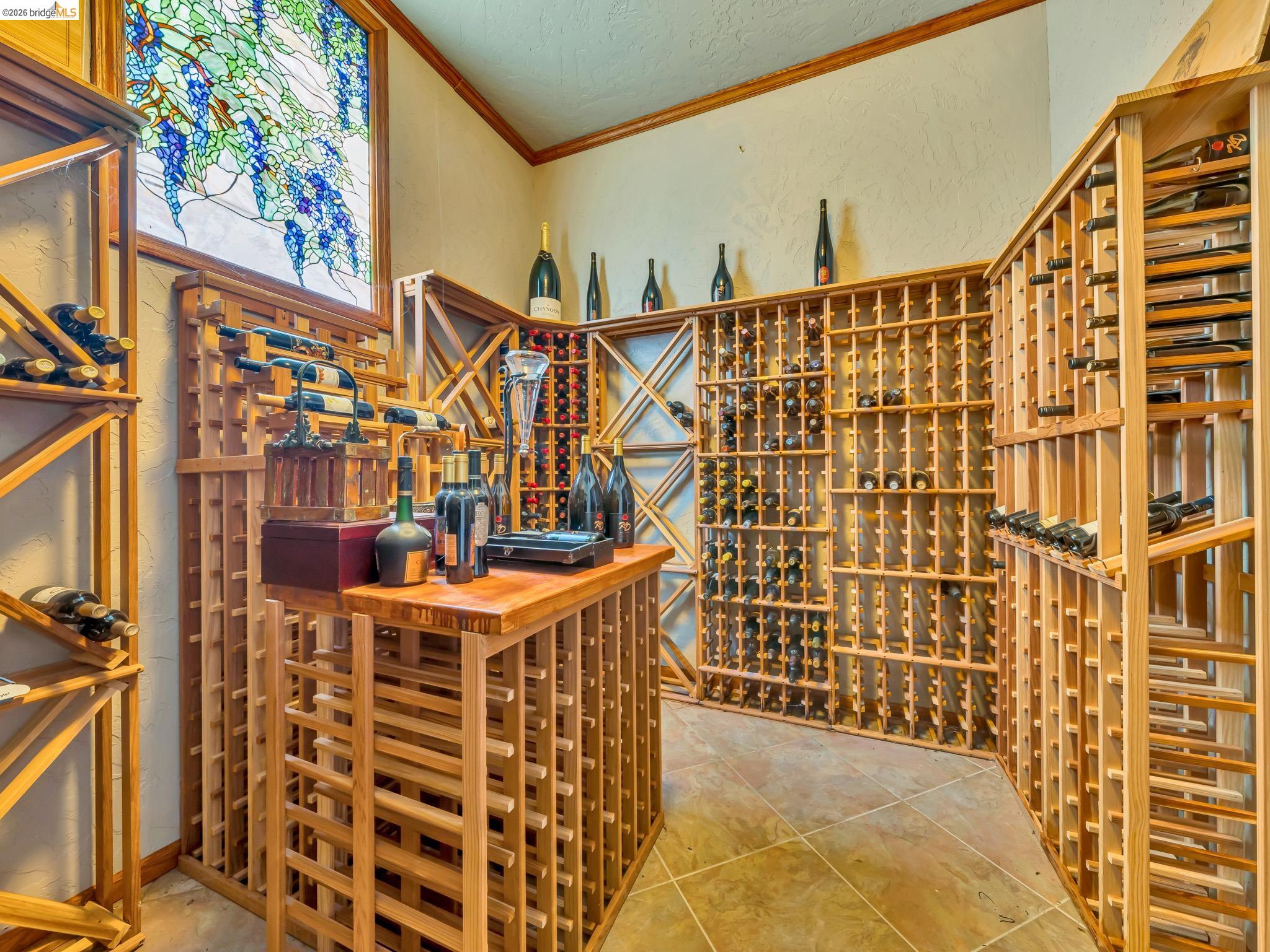 17035 Terminous Road Isleton, CA 95641 - Photo 38 of 48 Wine room featuring crown molding, a textured wall, and light tile patterned flooring