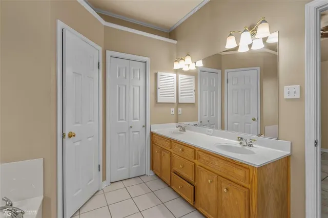 a spacious bathroom with a double vanity sink mirror and shower