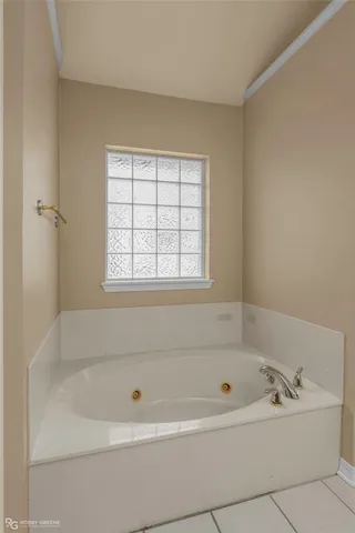 a white bath tub sitting next to a window