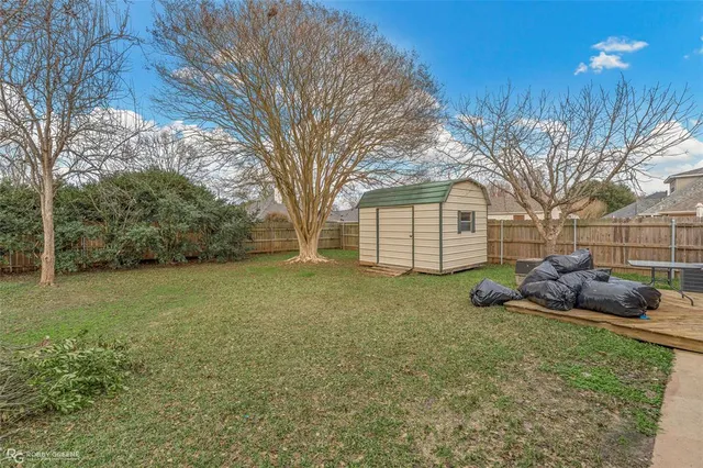 a view of a backyard with large trees