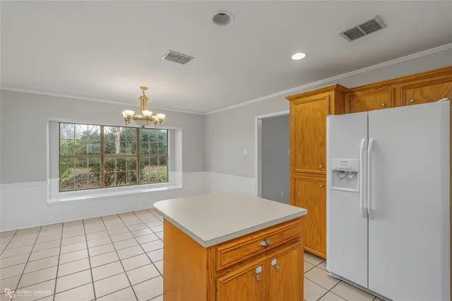 a kitchen with a refrigerator a sink and a cabinets