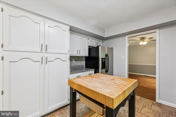 a kitchen with a table and refrigerator