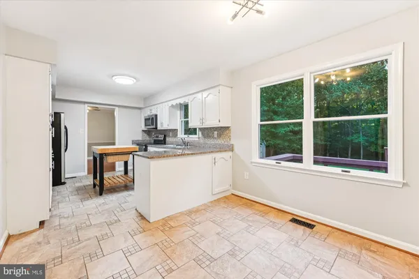 a kitchen with a sink cabinets and window