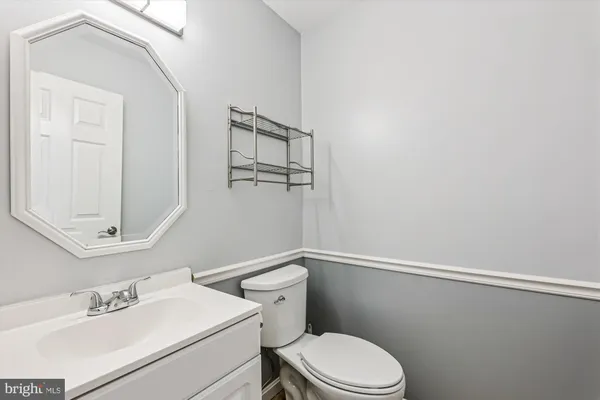 a white toilet sitting next to a bathroom sink