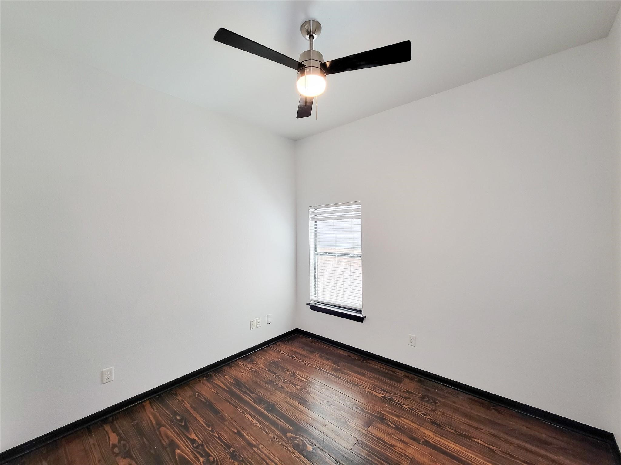 1904 Davis Street Houston, TX 77026 - Photo 19 of 33 a view of a room with wooden floor and a ceiling fan