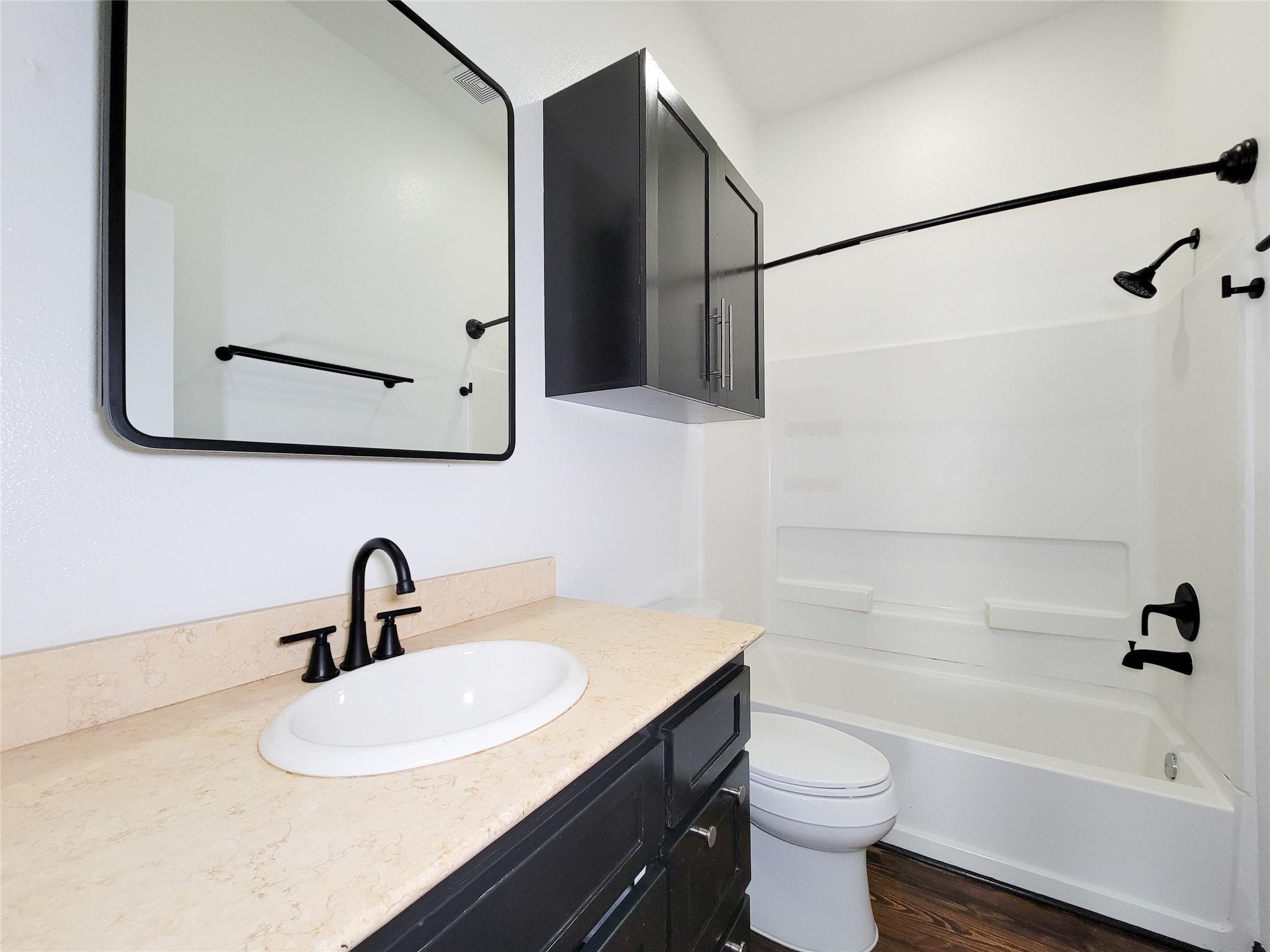 1904 Davis Street Houston, TX 77026 - Photo 22 of 33 a bathroom with a sink a toilet and a bathtub