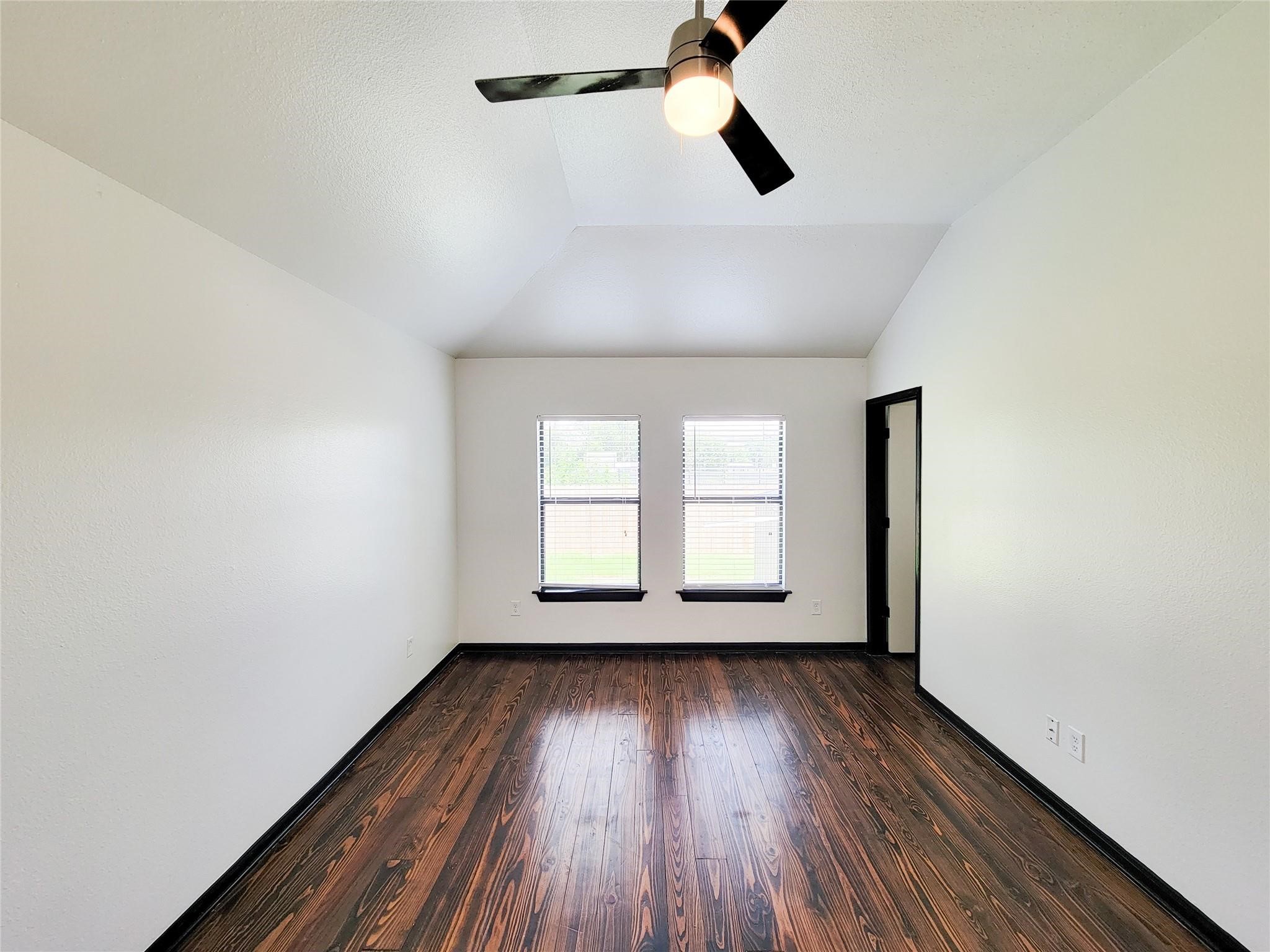 1904 Davis Street Houston, TX 77026 - Photo 25 of 33 an empty room with wooden floor fan and windows