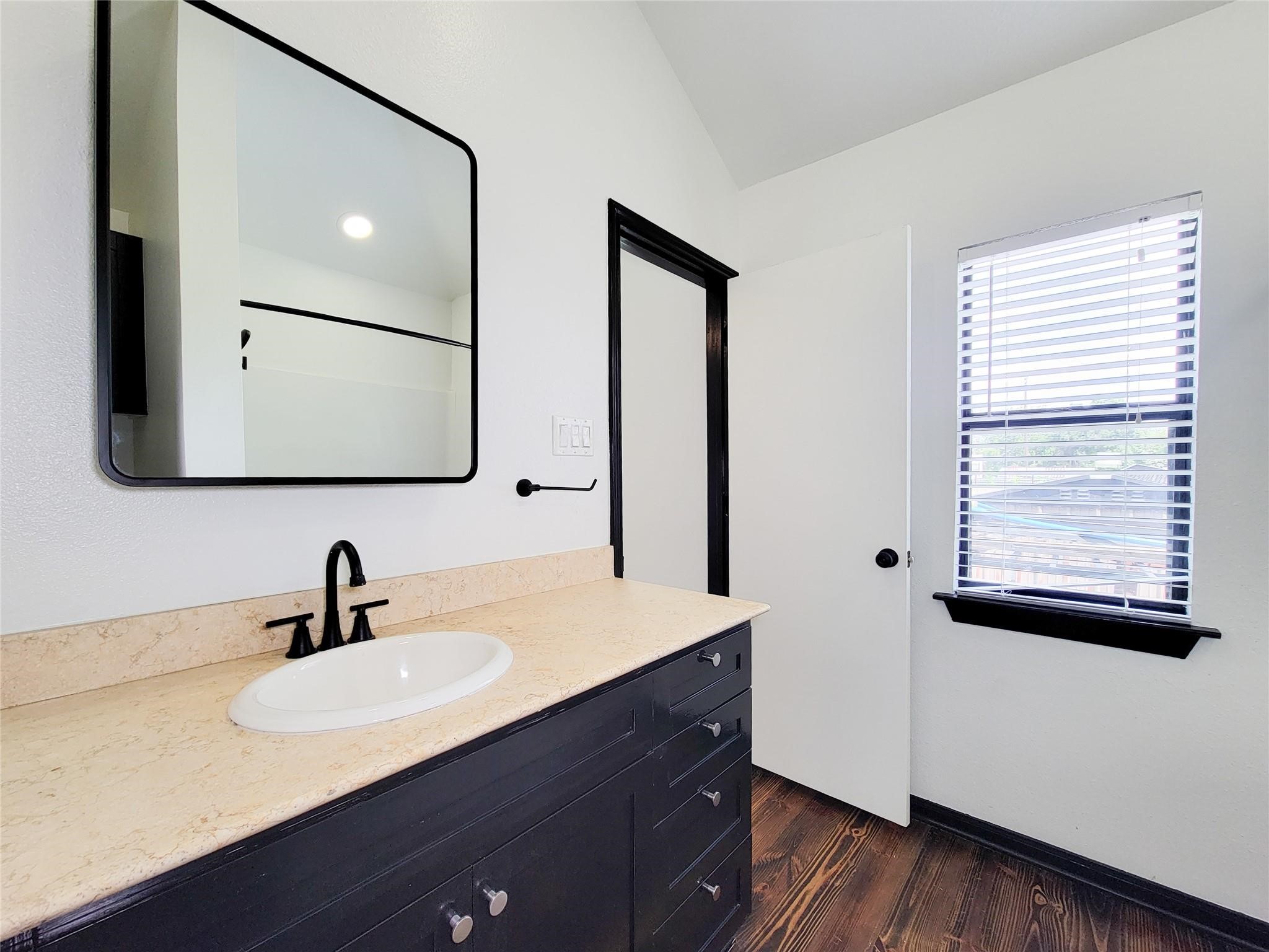 1904 Davis Street Houston, TX 77026 - Photo 30 of 33 a bathroom with a sink and a mirror