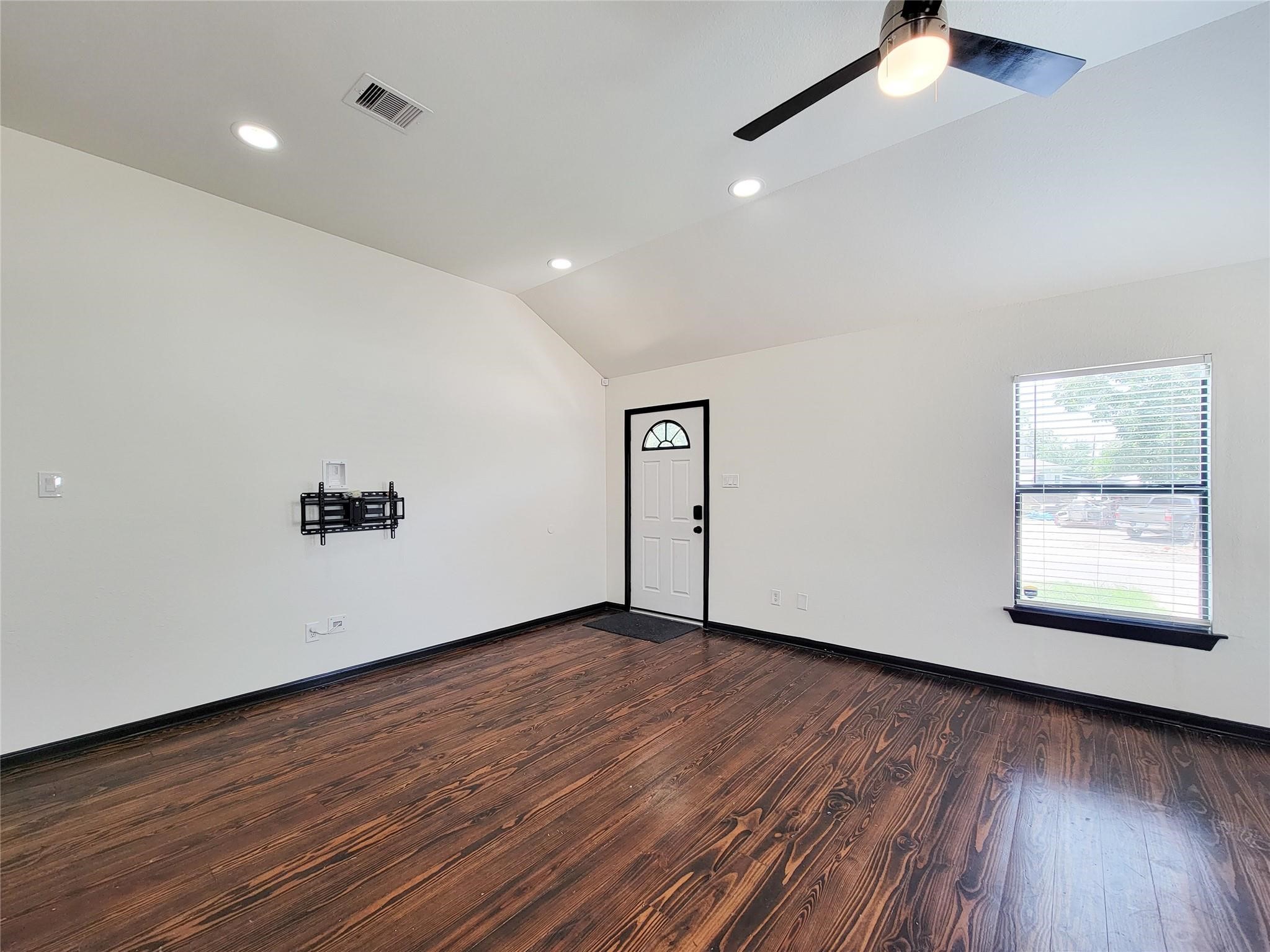 1904 Davis Street Houston, TX 77026 - Photo 3 of 33 an empty room with wooden floor and windows