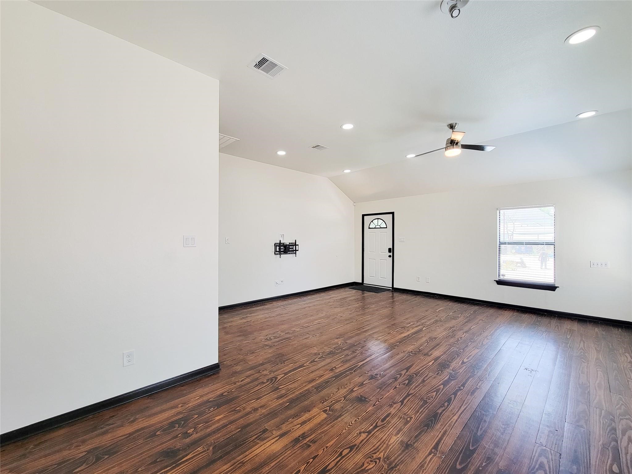 1904 Davis Street Houston, TX 77026 - Photo 8 of 33 an empty room with wooden floor and windows
