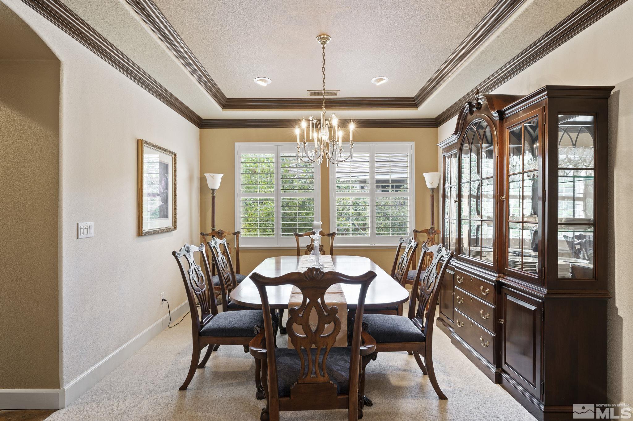 8150 Willow Ranch Trail Reno, NV 89523 - Photo 12 of 32 a view of a dining room with furniture wooden floor and chandelier