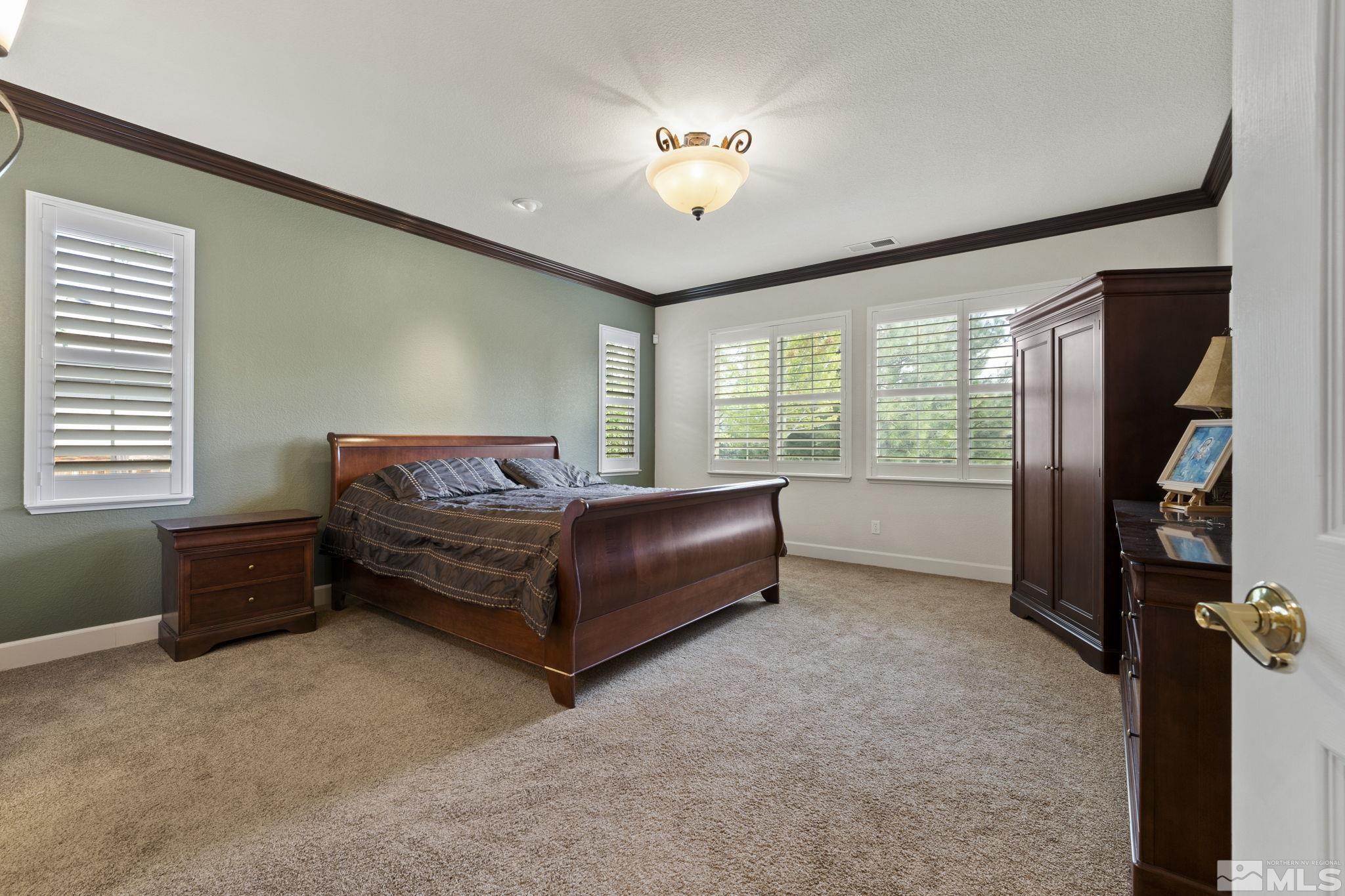 8150 Willow Ranch Trail Reno, NV 89523 - Photo 13 of 32 a bedroom with a bed and a chandelier