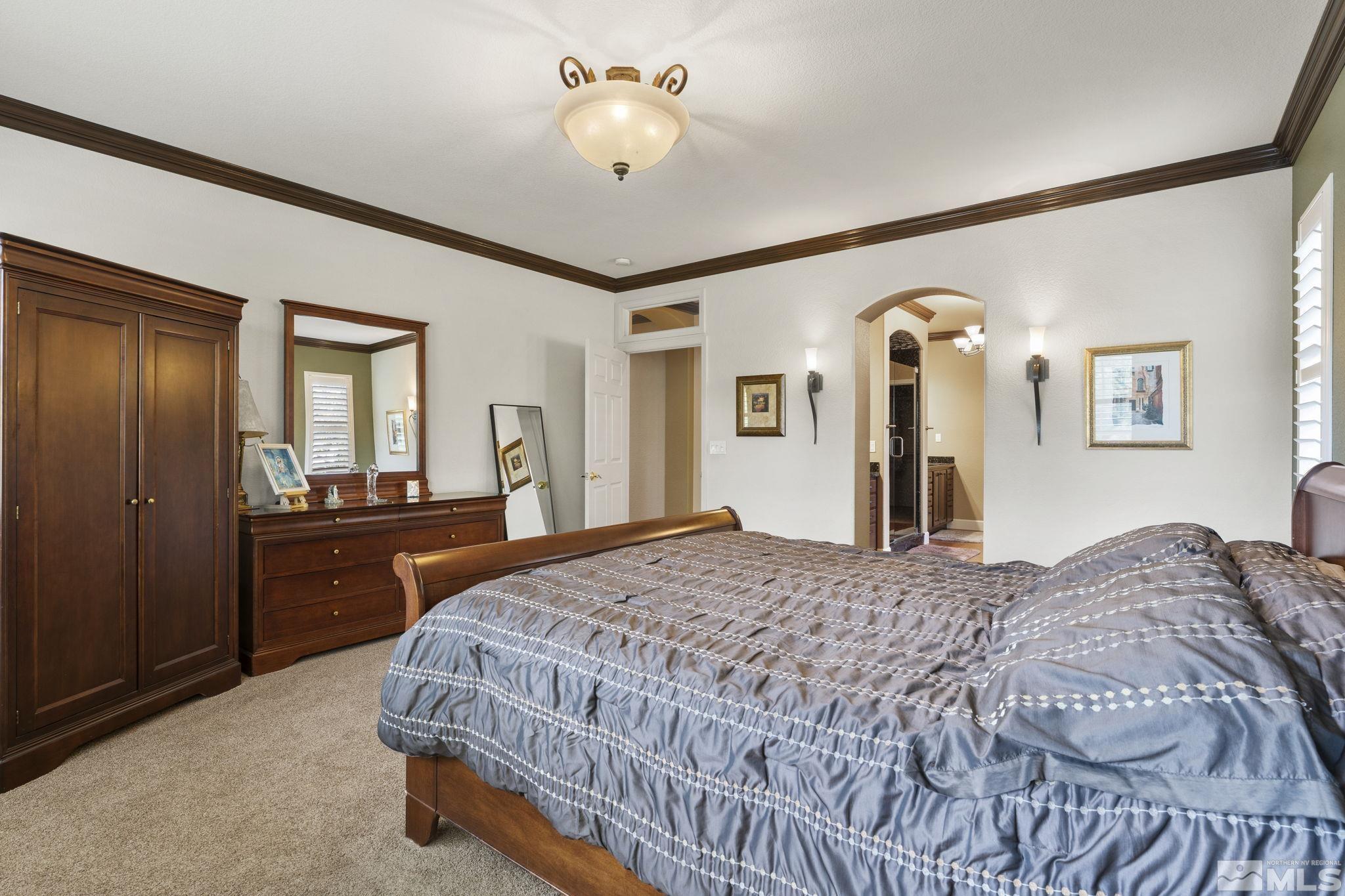 8150 Willow Ranch Trail Reno, NV 89523 - Photo 14 of 32 a bedroom with a bed and dresser with mirror