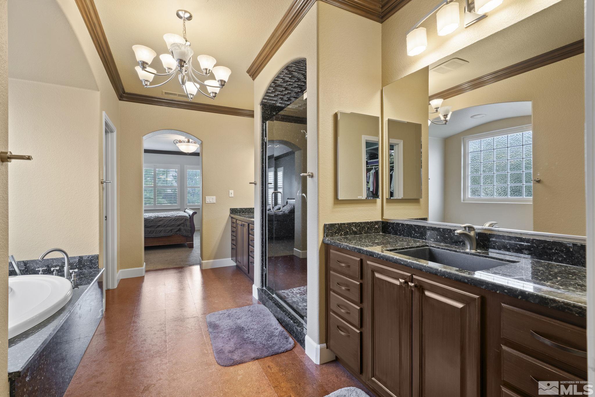 8150 Willow Ranch Trail Reno, NV 89523 - Photo 15 of 32 a en suite bathroom with a granite countertop sink a mirror and shower