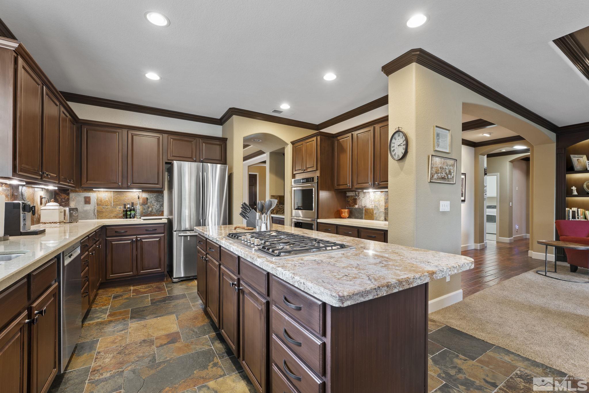 8150 Willow Ranch Trail Reno, NV 89523 - Photo 8 of 32 a kitchen with a stove refrigerator and a sink