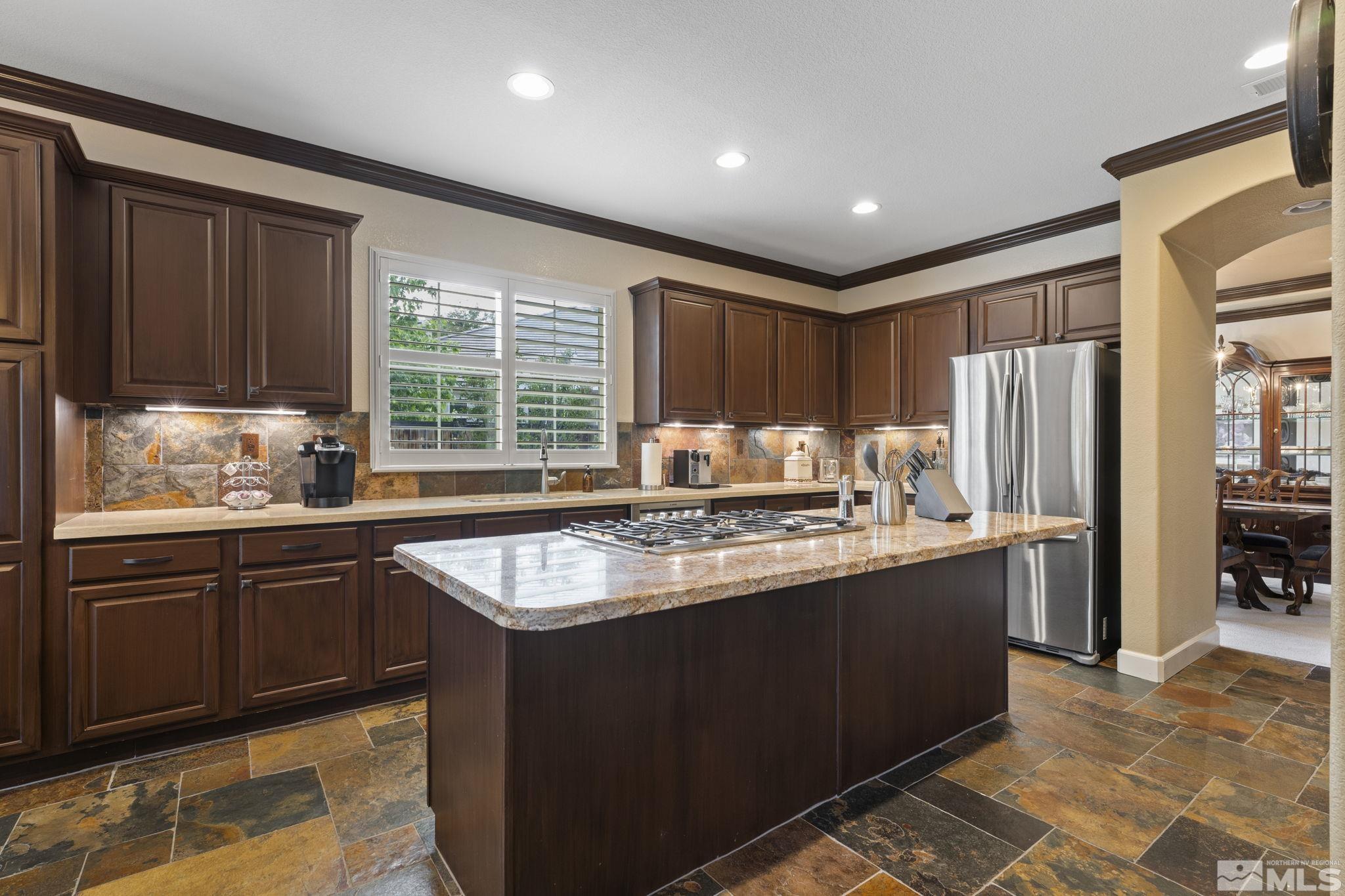 8150 Willow Ranch Trail Reno, NV 89523 - Photo 9 of 32 a kitchen with stainless steel appliances granite countertop a sink stove and refrigerator
