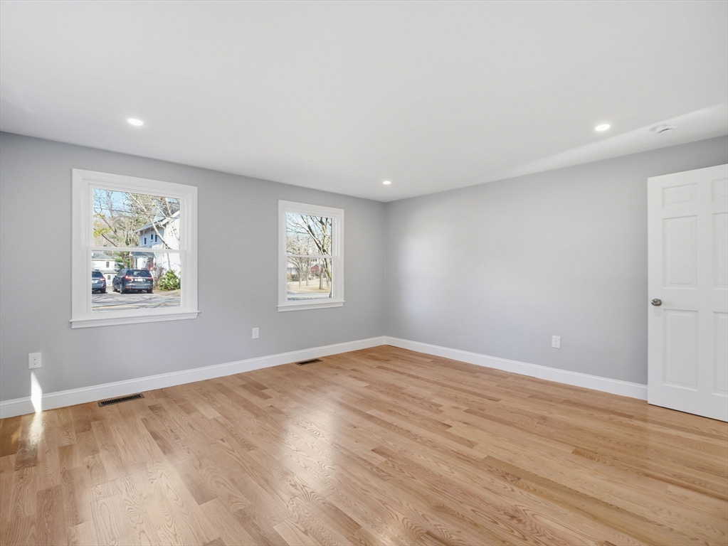58 Maple Street Framingham, MA 01702 - Photo 13 of 35 a view of empty room with wooden floor and window