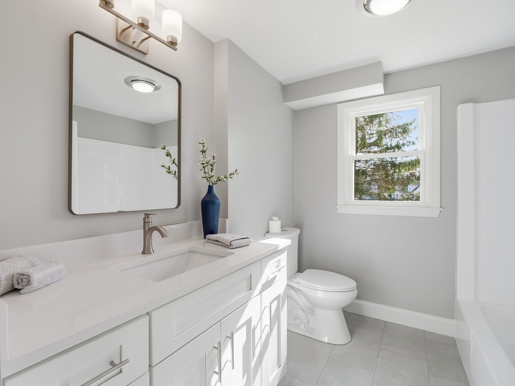 58 Maple Street Framingham, MA 01702 - Photo 14 of 35 a bathroom with a toilet a sink and mirror