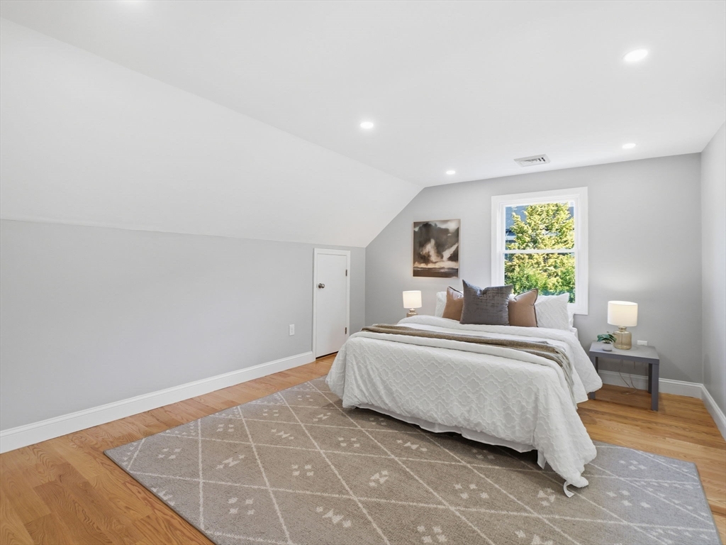 58 Maple Street Framingham, MA 01702 - Photo 15 of 35 a spacious bedroom with a bed and a large window