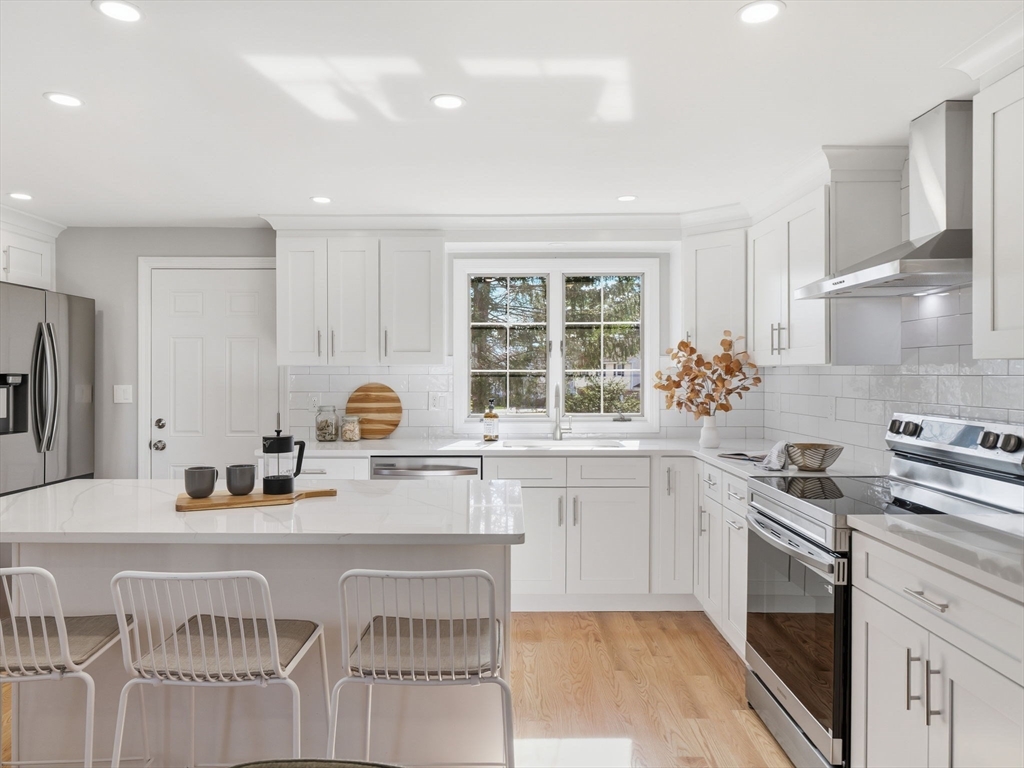 58 Maple Street Framingham, MA 01702 - Photo 4 of 35 a kitchen with a sink stove and cabinets