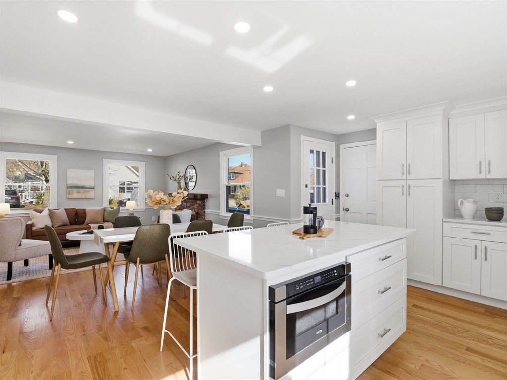 58 Maple Street Framingham, MA 01702 - Photo 8 of 35 a open kitchen with stainless steel appliances white cabinets and wooden floor