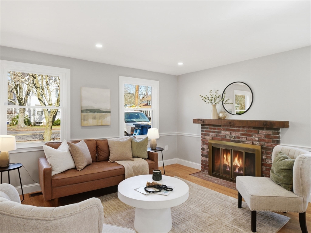 58 Maple Street Framingham, MA 01702 - Photo 9 of 35 a living room with furniture a window and a fireplace