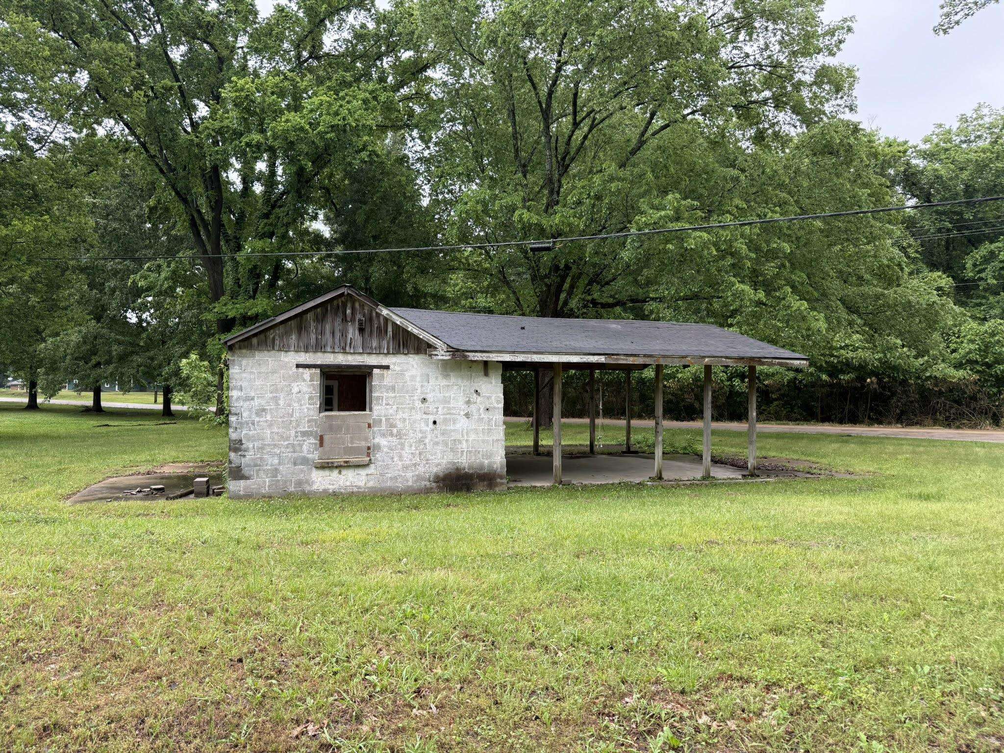 2102 Campbell Road Millington, TN 38053 - Photo 14 of 18 Block construction utility building featuring a covered carport structure and a dark shingle roof