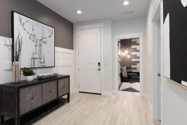 a hallway with mirror on the wall