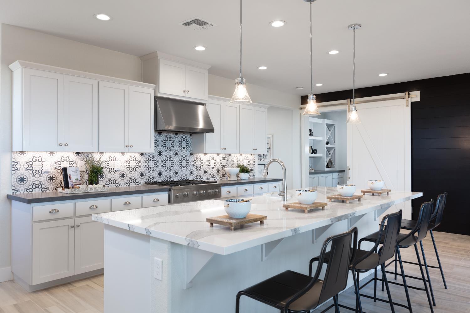 12704 Castaic Lk Way Rancho Cordova, CA 95742 - Photo 6 of 13 a kitchen with stainless steel appliances kitchen island granite countertop a sink and cabinets