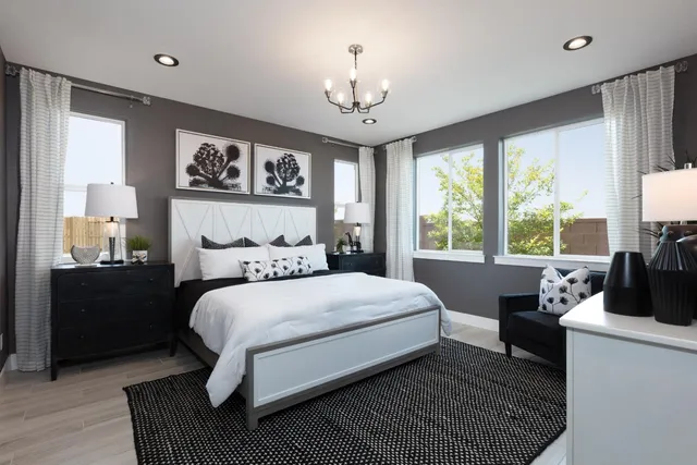 a bedroom with a bed wooden floor and window