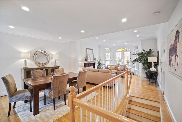 a view of a dining room with furniture and a kitchen
