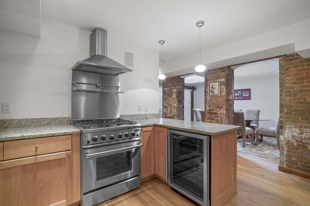5 Durham Street, Unit 2 Boston, MA 02115 - Photo 11 of 22 a kitchen with a stove and a wooden floor