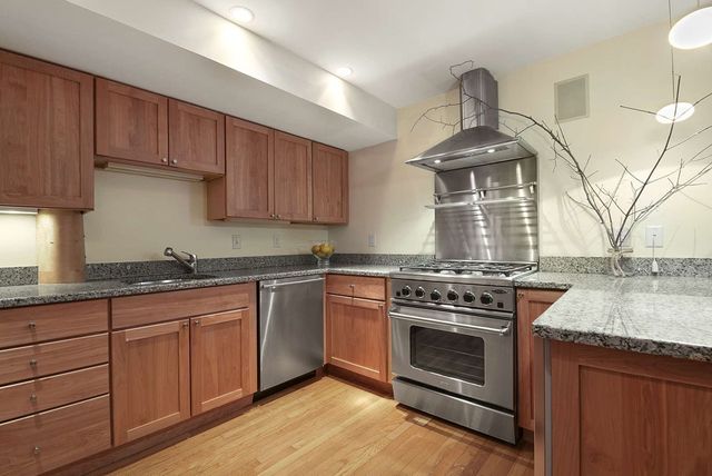 a kitchen with stainless steel appliances granite countertop a stove and a sink